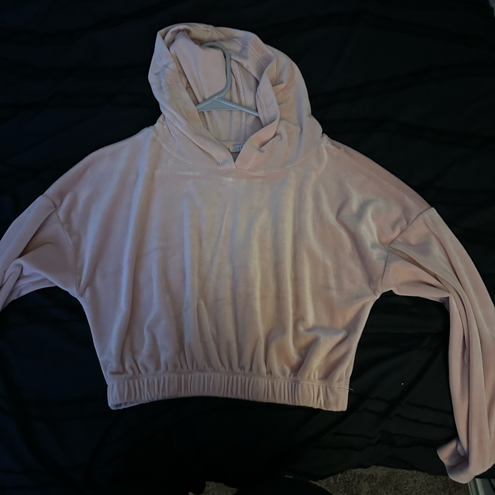 This is a pink crop top hoodie.